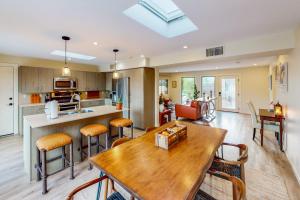 a kitchen and living room with a table and chairs at Adobe Barona Dream in Palm Springs
