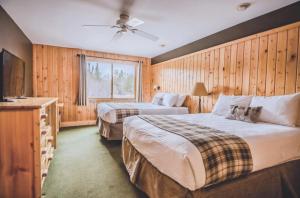 a hotel room with two beds and a television at Superior Shores Resort in Two Harbors +95 photos