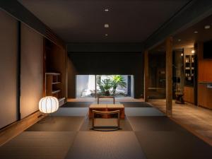 a living room with a couch and a table at MU HEN KO Q -Nara- in Nara