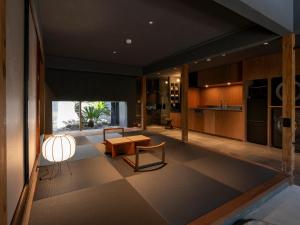a living room with a table and a kitchen at MU HEN KO Q -Nara- in Nara