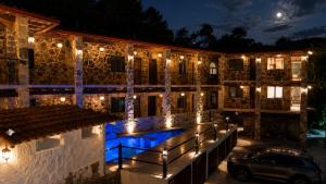 a building with lights on it at night at La Peña Hotel Boutique & SPA in Cuetzalán del Progreso
