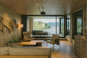 a living room with a couch and a table at HOTEL & KOTEI SOKA in Kyotango