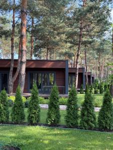 a house in the middle of a yard with trees at Grace Place in Soshnikov
