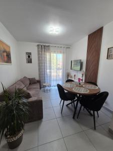 a living room with a couch and a table at Charmant T2 in Calvi