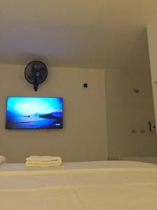 a television hanging on a wall in a bedroom at Mejor Hotel, Centro Medellín, Opera, adults only entertainment in Medellín +19 photos