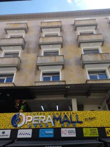 a building with a yellow sign in front of it at Mejor Hotel, Centro Medellín, Opera, adults only entertainment in Medellín
