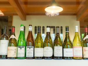 a row of wine bottles sitting on a shelf at Ikiru Lodge in Yamanouchi
