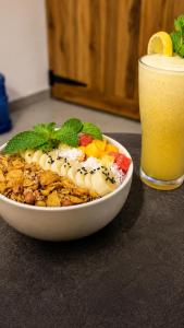 a bowl of food on a table with a glass of orange juice at TK Stay in Arugam Bay
