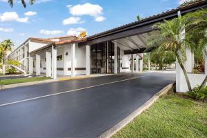 an empty road in front of a building at Super 8 by Wyndham Riviera Beach West Palm Beach in Riviera Beach