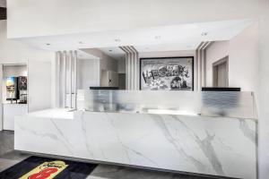 a lobby with a white marble counter top at Super 8 by Wyndham Riviera Beach West Palm Beach in Riviera Beach +21 photos