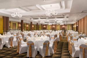 a banquet hall with white tables and chairs at Ramada Colombo in Colombo +93 photos