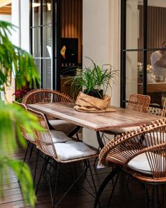 a wooden table with chairs and a plant on it at DOM Boutique Hotel in Heraklio
