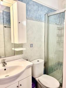 a bathroom with a toilet and a sink and a shower at Lotos Suite in Kini +21 photos