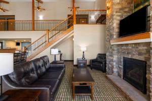 a living room with a couch and a fireplace at Baymont by Wyndham Oacoma in Oacoma