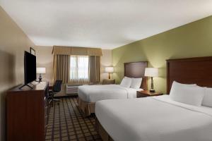 a hotel room with two beds and a television at Baymont by Wyndham Oacoma in Oacoma +54 photos