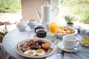 a table with a breakfast of eggs and bacon at Maskam Guest Farm in Vanrhynsdorp