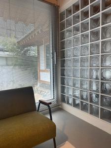 a living room with a wall of glass plates at Stay Jian in Daegu