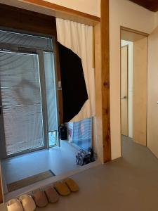 a room with a window with slippers on the floor at Stay Jian in Daegu