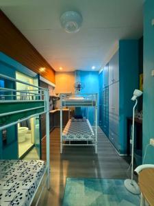 a room with two bunk beds and blue walls at Peach Haven in Cebu City