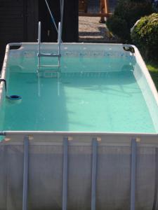 a pool of blue water with a chair in it at HIT- house in Slavske