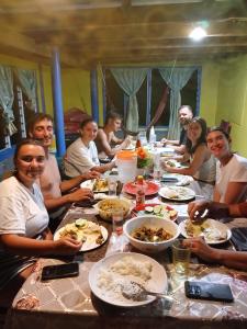 a group of people sitting around a table eating food at Salote homestay in Lautoka +21 photos