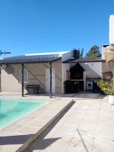 a house with a patio and a swimming pool at Caralíhome in Esquina
