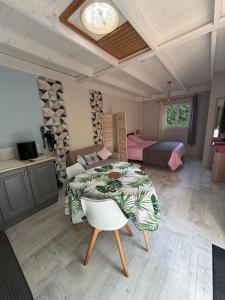 ein großes Zimmer mit einem Tisch und einem Bett in der Unterkunft Gites Matilon, 5 min Eugénie les bains in Buanes