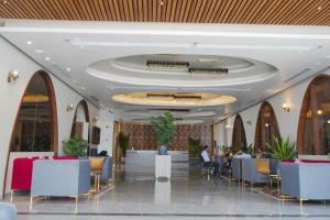 a lobby of a hotel with tables and chairs at Barsana Hotel & Resorts in Jaipur +43 photos