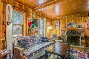 a living room with a couch and a fireplace at Walden in the Woods in Idyllwild
