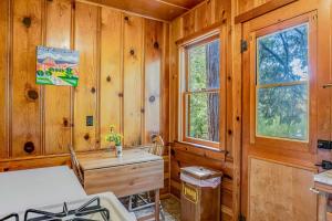 a wooden room with a desk and a window at Walden in the Woods in Idyllwild