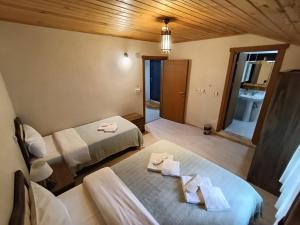 a room with two beds and a table with towels at Long Lake pansiyon in Uzungöl