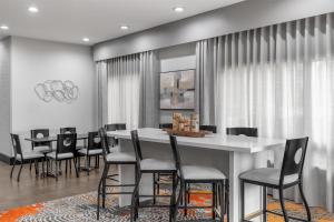 a dining room with a white table and chairs at Hampton Inn Olathe in Olathe +64 photos