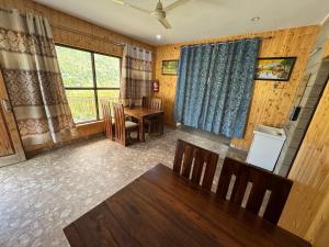 a living room with a table and a dining room at ROYALE PEAKS villa sonamarg Rd in Harganyiwan