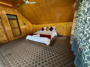 a bedroom with two beds and a wooden ceiling at ROYALE PEAKS villa sonamarg Rd in Harganyiwan