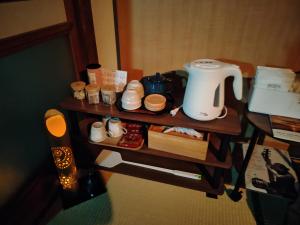 a table with a coffee maker and shoes on it at ブラボーワールド in Shimabara +20 photos