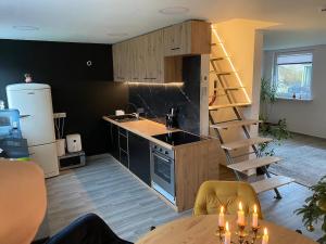 a kitchen with a sink and a kitchen with a stove at Zacišių Sodyba in Karalgiris
