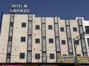 a large building with a hotel corporate sign on it at Hotel Corporate in Shivpurī +1 photo
