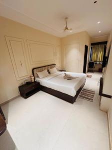 a bedroom with a large bed in a room at Hotel Corporate in Shivpurī