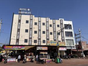 a large building with a sign on top of it at Hotel Corporate in Shivpurī
