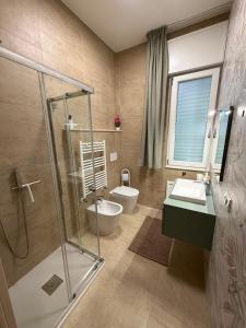 a bathroom with a shower and a sink and a toilet at VillaVenere in Rossano +42 photos
