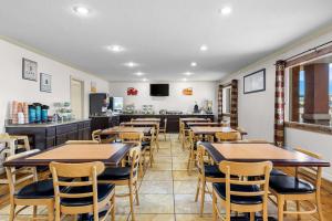 a restaurant with tables and chairs and a counter at Quality Inn Evanston near Wyoming Downs in Evanston