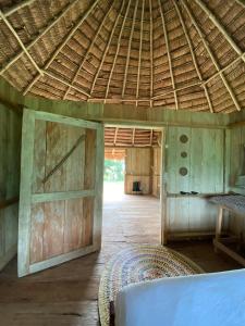 an inside view of a building with a straw roof at Hostal Maguare-Reserva Indígena Maguare in Leticia +42 photos