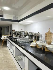 a kitchen with a counter with dishes on it at Hotel Dera Bukhara in Bukhara