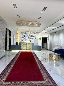 a large lobby with a red carpet in the middle at Hotel Dera Bukhara in Bukhara +47 photos