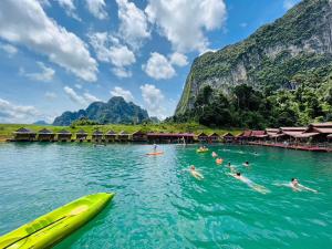 a group of people swimming in the water at a resort at Khaosok Diary Camp in Khao Sok National Park