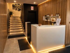 a hallway with a staircase with a white counter and a stair case at Galaxy Apartments in Belgrade