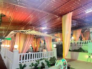 a room with a ceiling with curtains and an elephant at Motus Mountain view Hotels in Jambhulpāda +15 photos