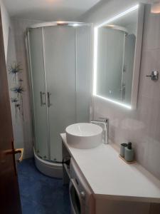 a white bathroom with a sink and a shower at Mario in Martinšćica +9 photos