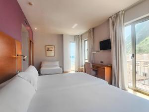 a hotel room with a large bed and a window at Hotel Faranda Marsol Candas, Ascend Hotel Collection in Candás