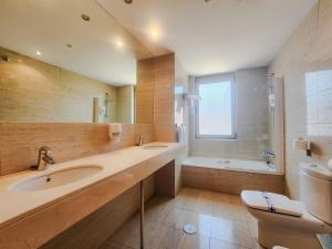 a bathroom with a sink and a shower and a toilet at Hotel Faranda Marsol Candas, Ascend Hotel Collection in Candás